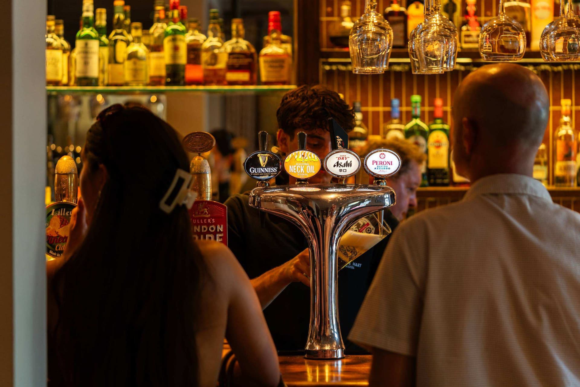 Bartender pouring beer for guests
